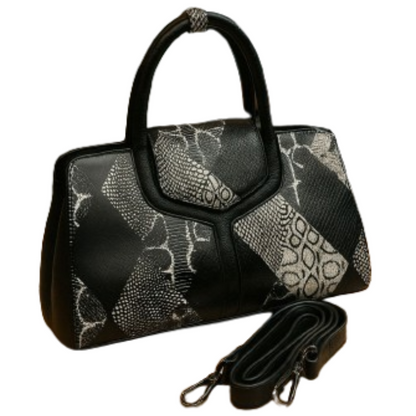 Black handbag with white pattern and detachable strap on a white background