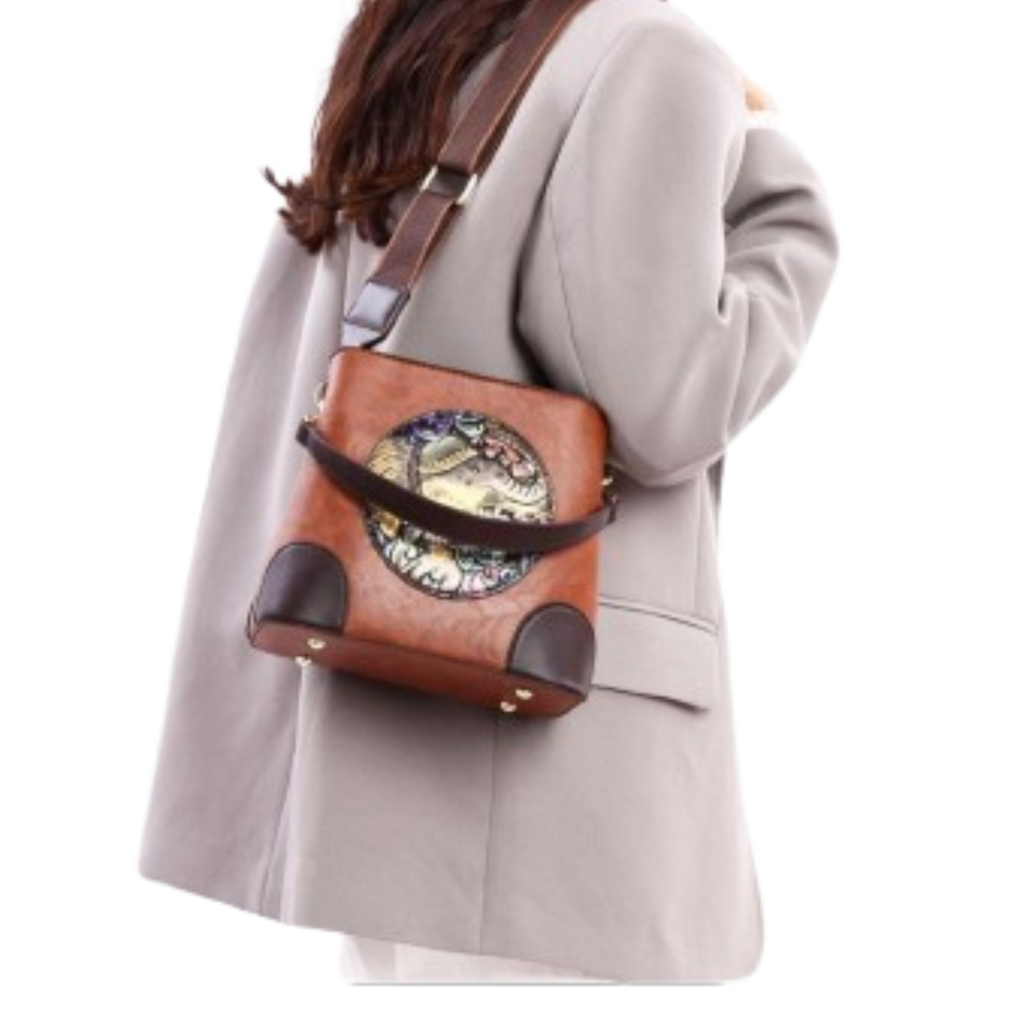 Person wearing a brown leather bag with decorative elements on a white background