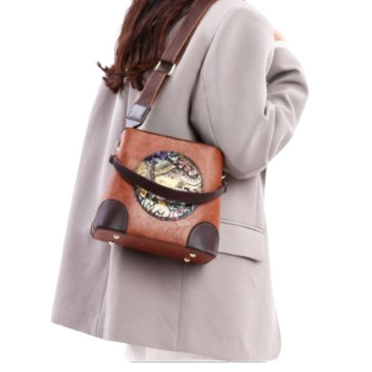 Person wearing a brown leather bag with decorative elements on a white background