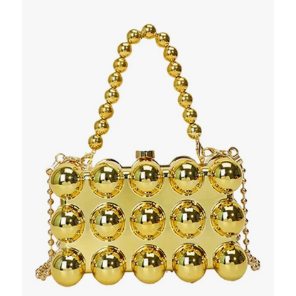 Gold handbag with spherical design and beaded handle on a white background
